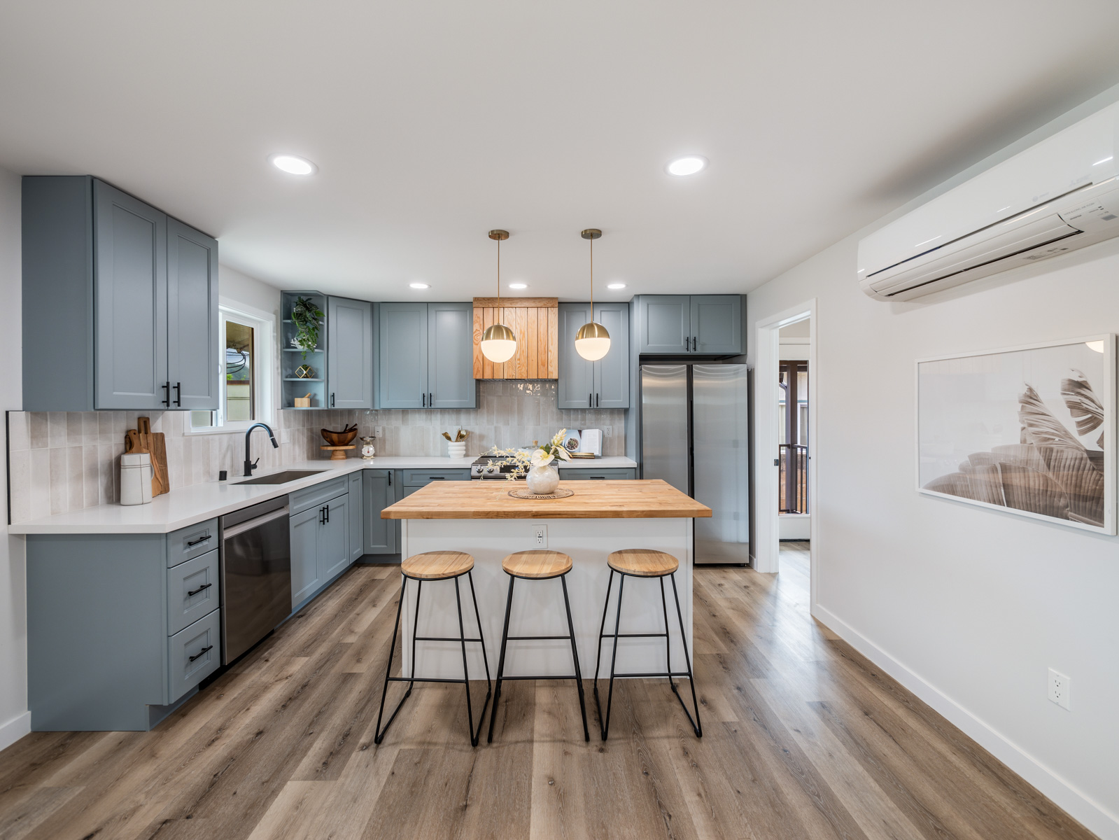 45-561 Paleka Road, Unit C Kaneohe, HI 96744 - Photo 1 of 27 a kitchen with stainless steel appliances a dining table chairs microwave and sink