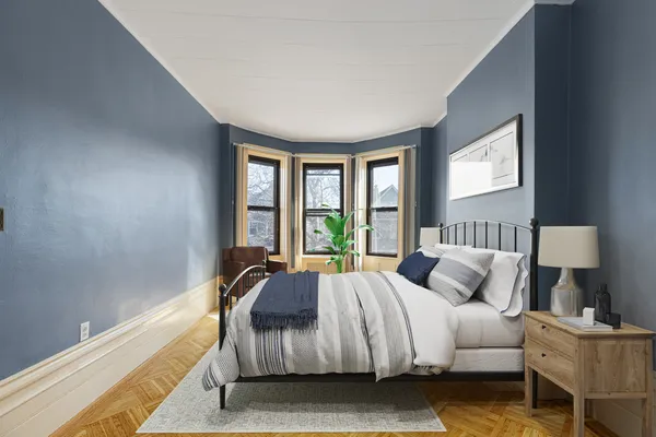 a spacious bedroom with a bed and a couch