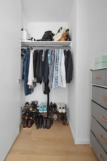 a view of walk in closet with clothes and shoes