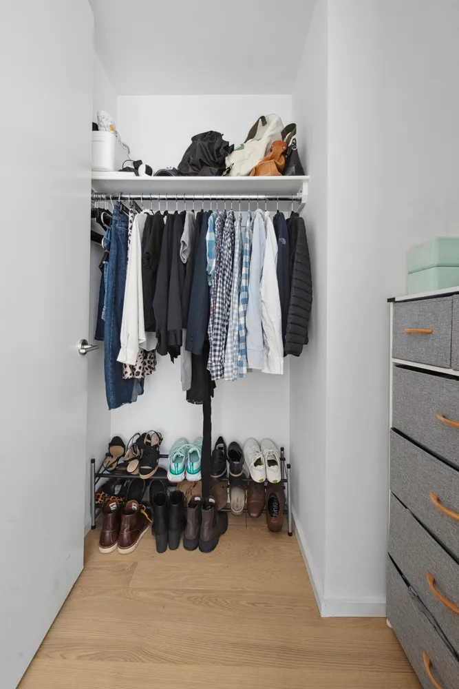a view of walk in closet with clothes and shoes