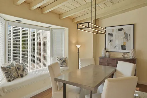 a dining room with furniture a rug and wooden floor