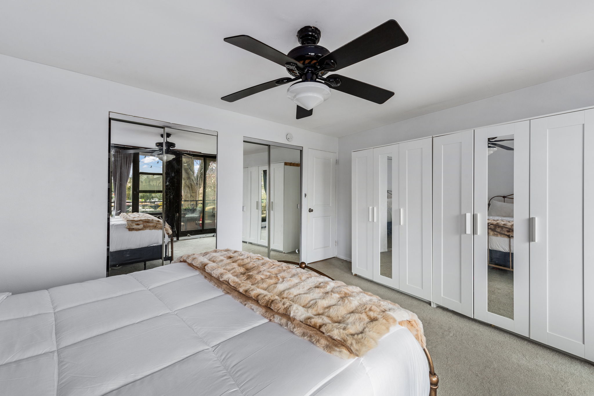 11-01 162nd Street, Unit 3D Queens, NY 11357 - Photo 10 of 16 a bedroom with a large bed and a chandelier