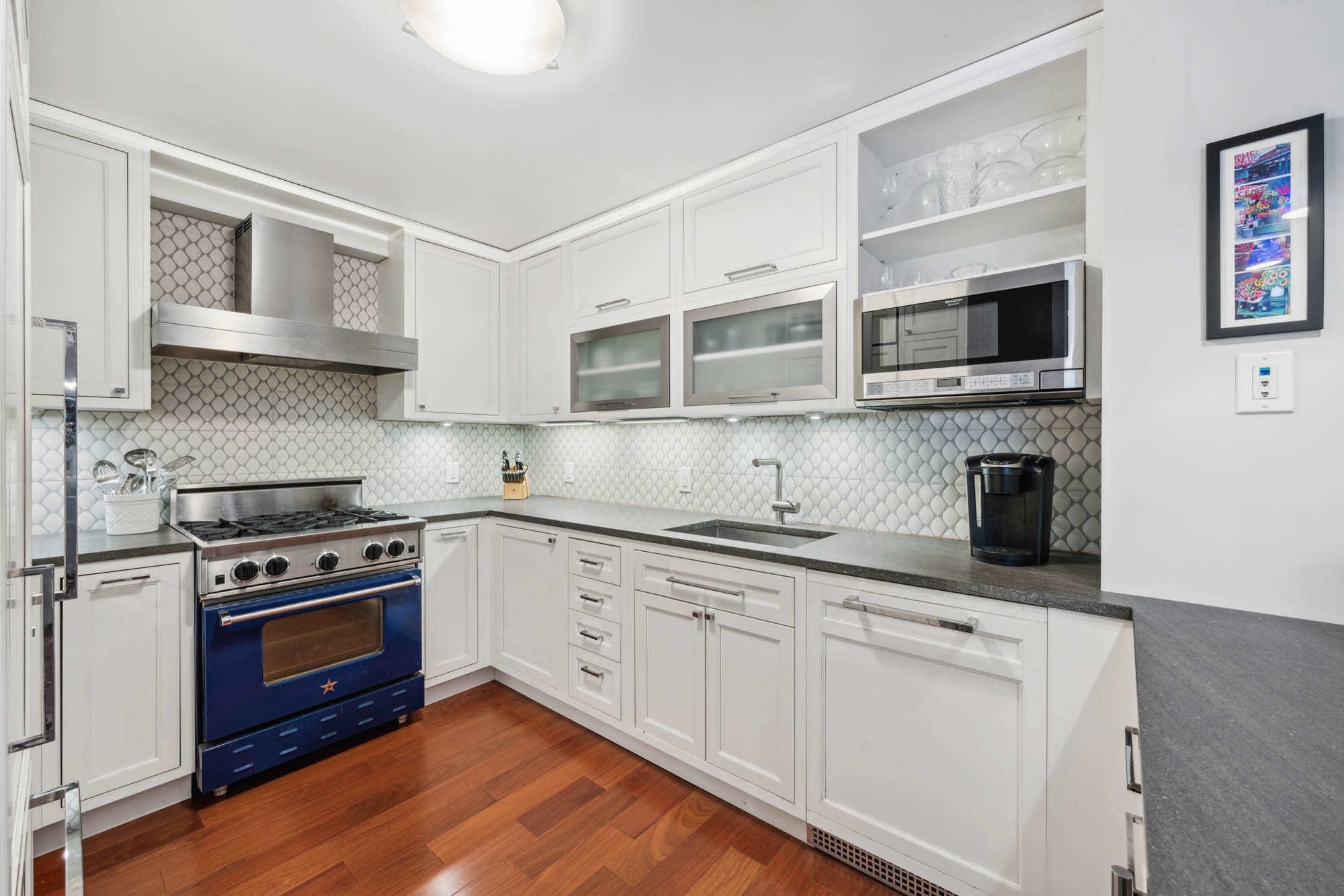 420 East 72nd Street, Unit 2J Manhattan, NY 10021 - Photo 4 of 12 a kitchen with stainless steel appliances granite countertop a stove and a sink
