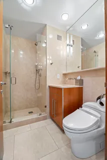 a bathroom with a sink a toilet and shower