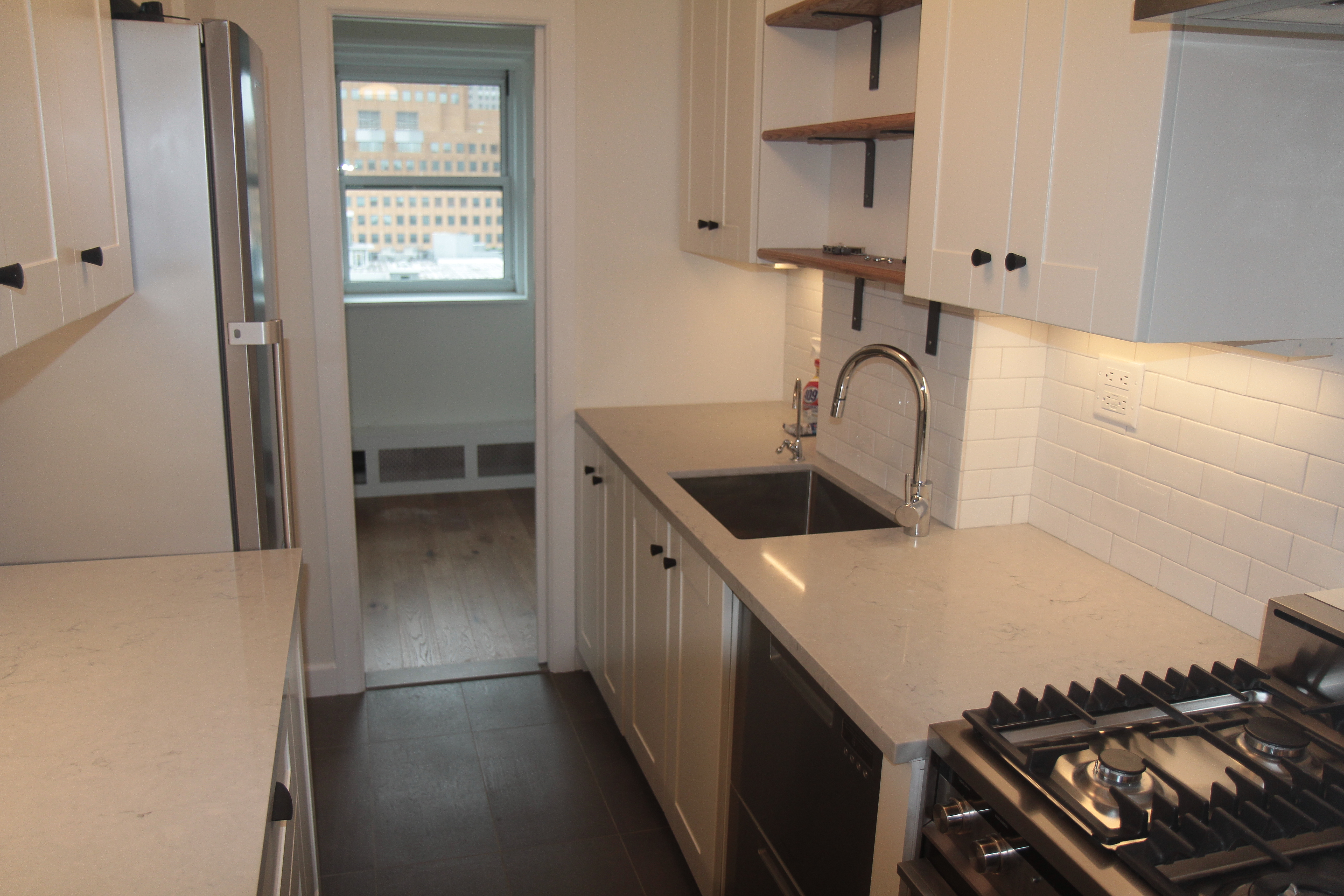 191 Willoughby Street, Unit 12J Brooklyn, NY 11201 - Photo 11 of 19 a kitchen with a stove and a sink