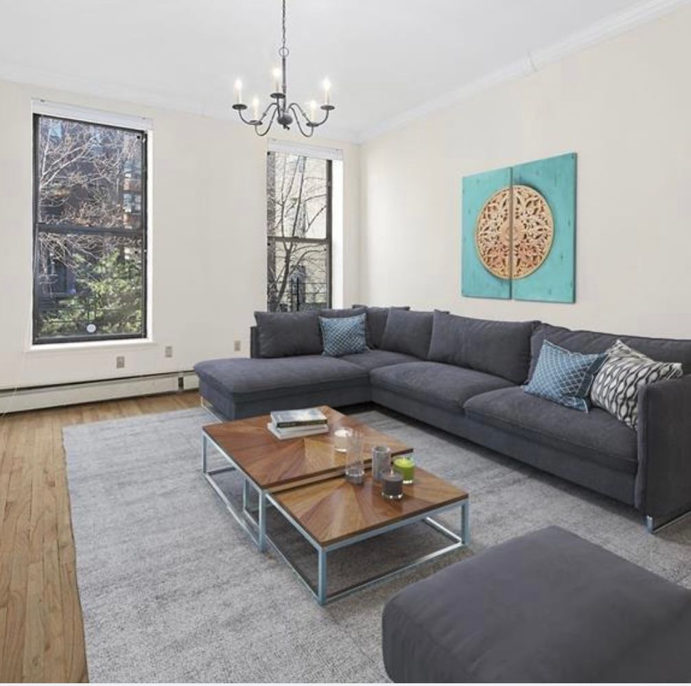 a living room with furniture and a chandelier