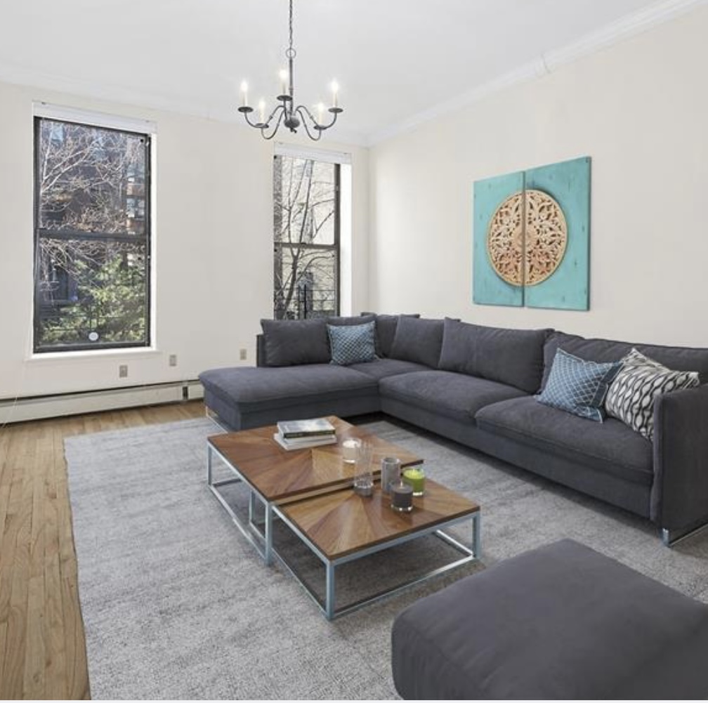 a living room with furniture and a chandelier