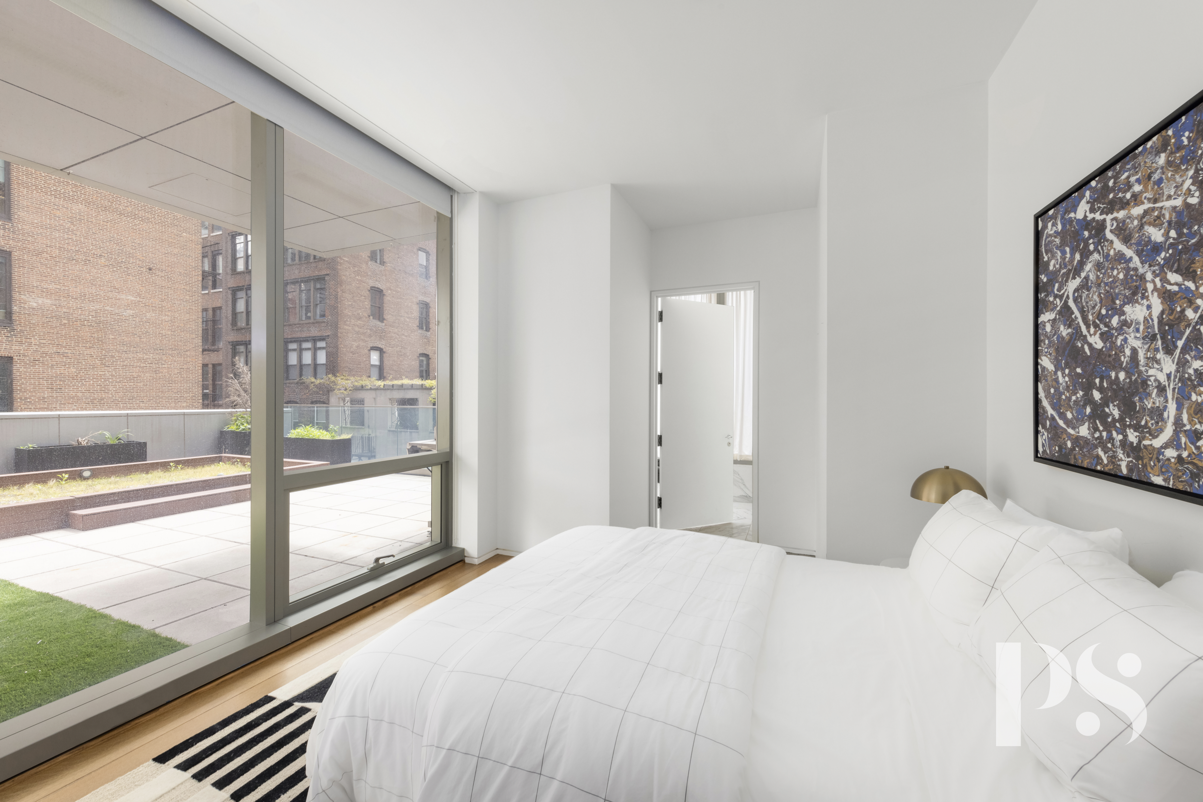 23 East 22nd Street, Unit 8A Manhattan, NY 10010 - Photo 13 of 25 a bedroom with a bed and a large window with outer view