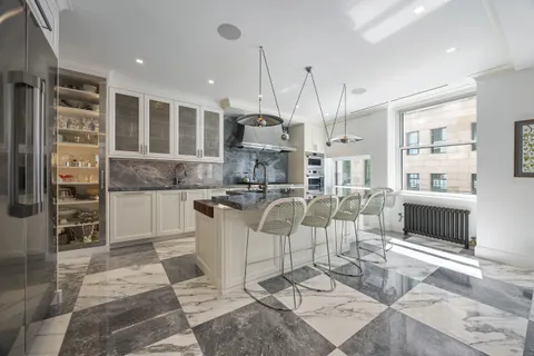 a living room with furniture a fireplace and kitchen view