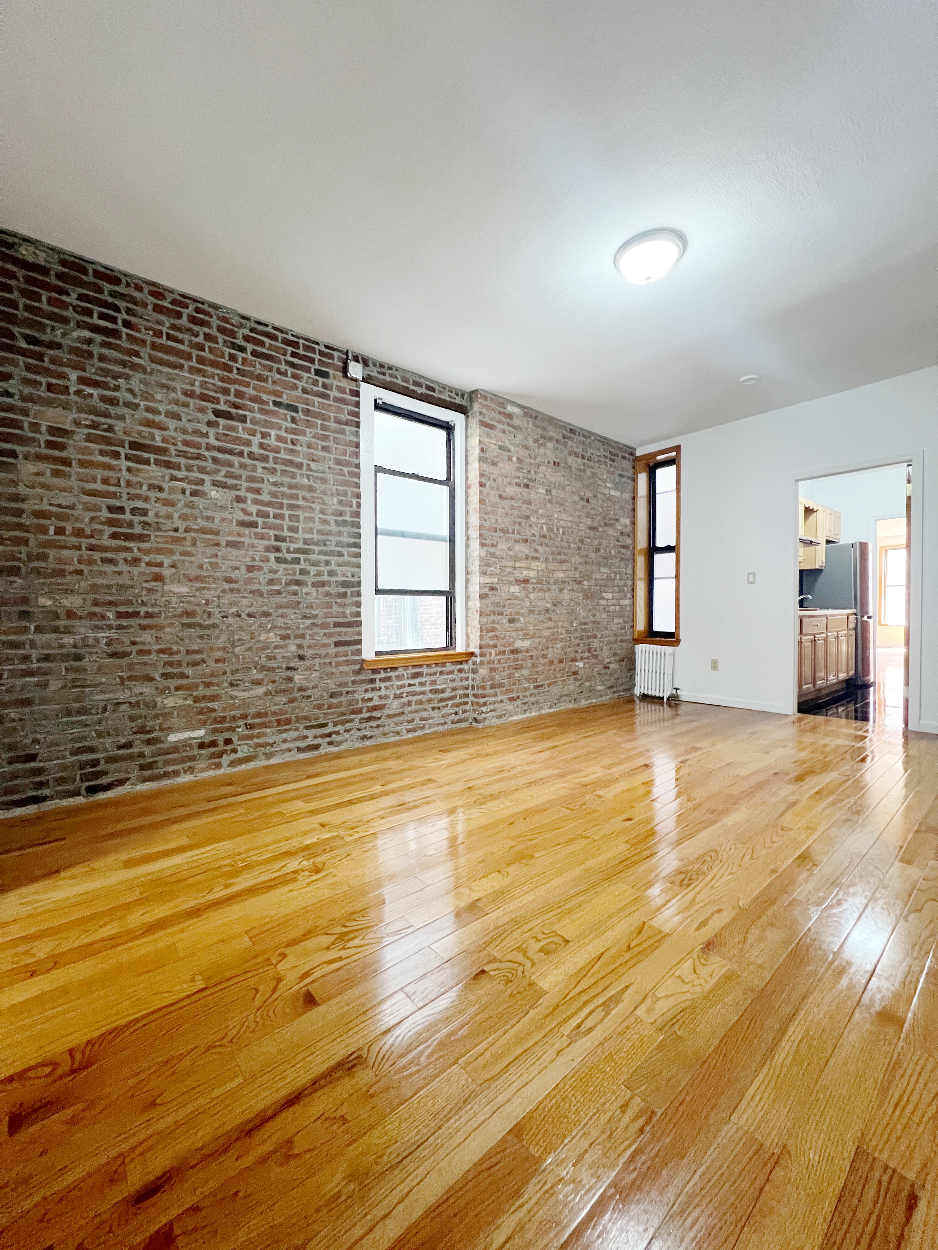 75 Madison Street, Unit 6 Manhattan, NY 10002 - Photo 2 of 5 a view of an empty room with a window