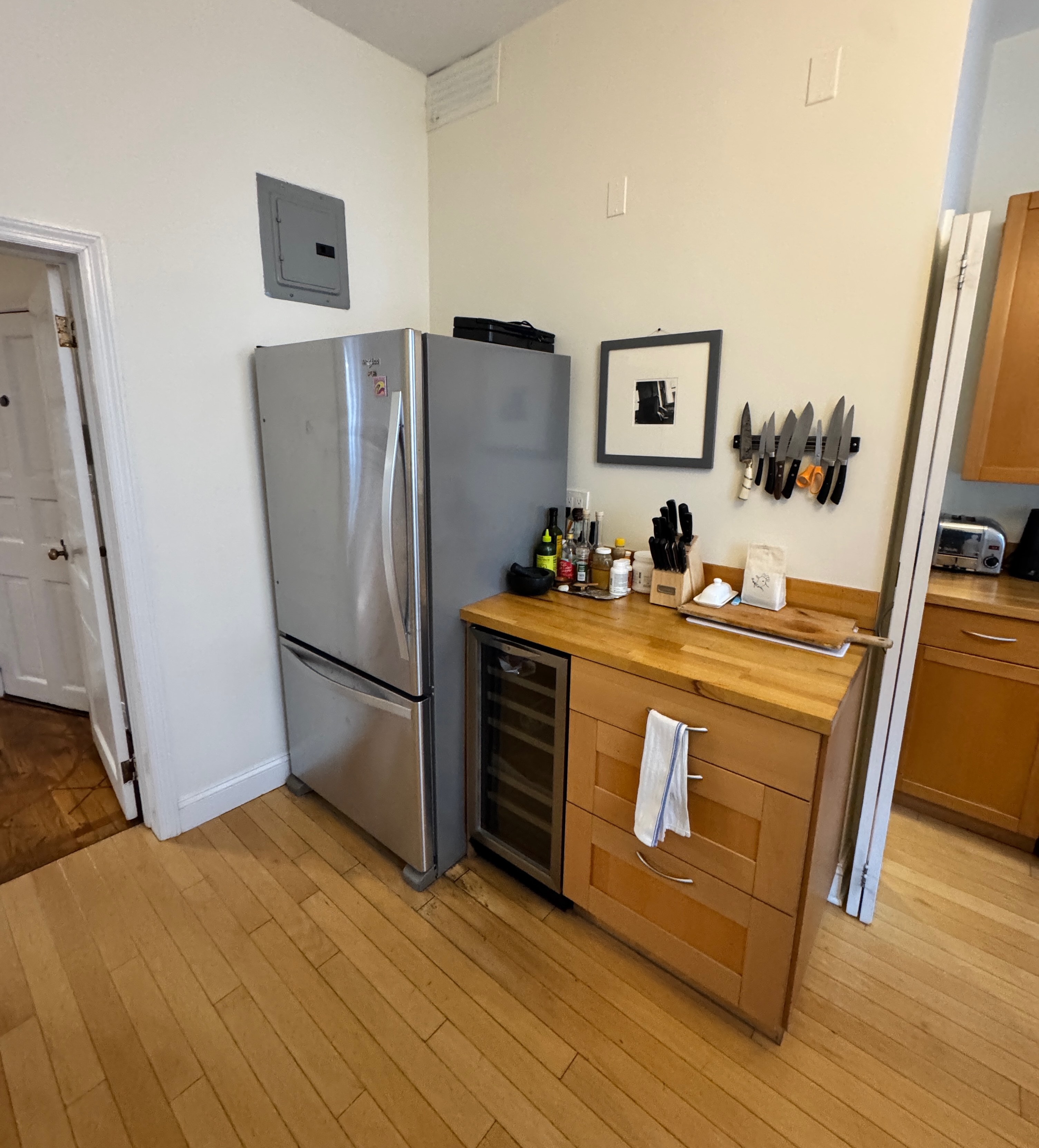 19 Vandam Street, Unit 2 Manhattan, NY 10014 - Photo 17 of 19 a kitchen with stainless steel appliances a refrigerator stove and wooden floor