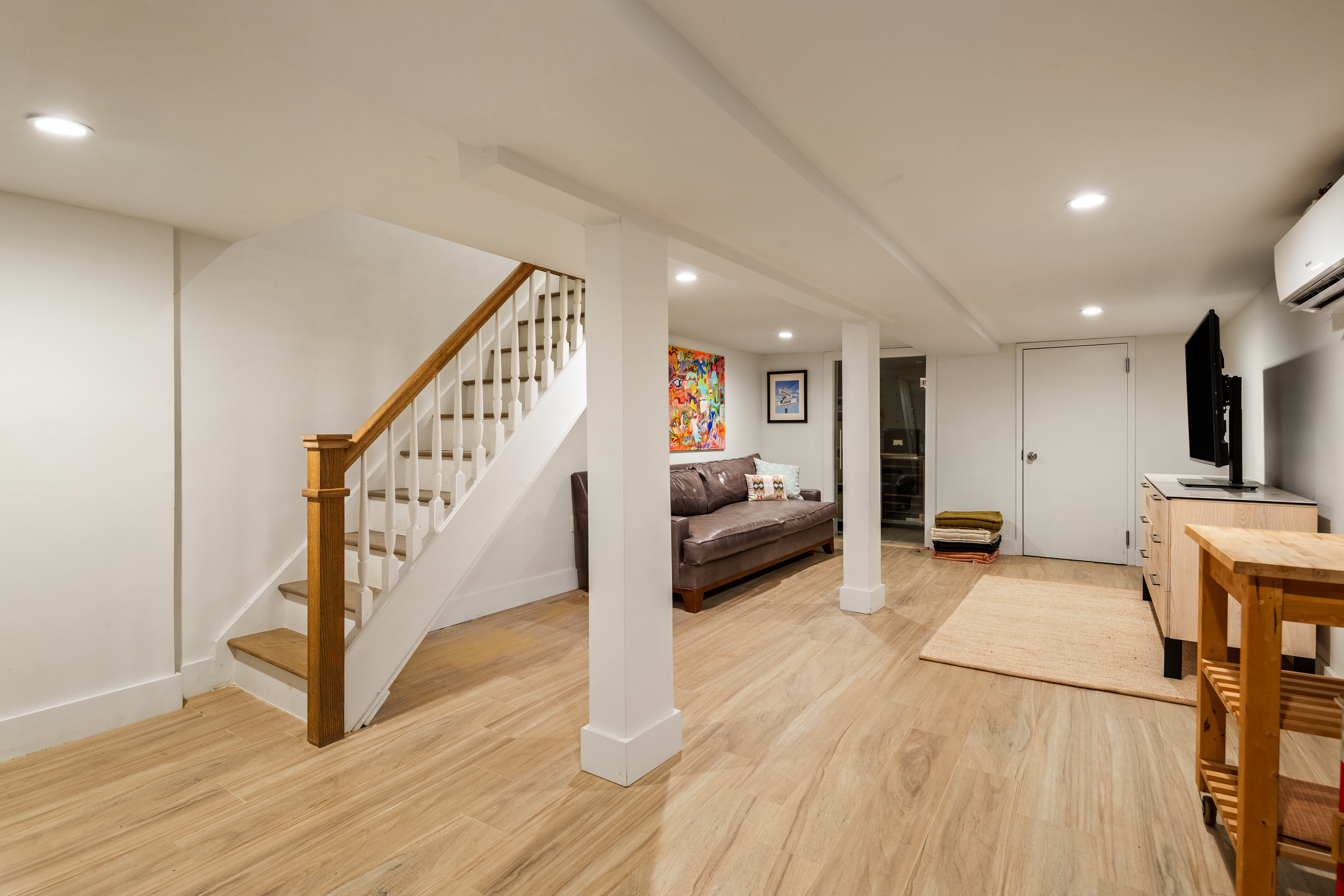 197 Madison Street Brooklyn, NY 11216 - Photo 16 of 19 a view of a livingroom with wooden floor and stairs