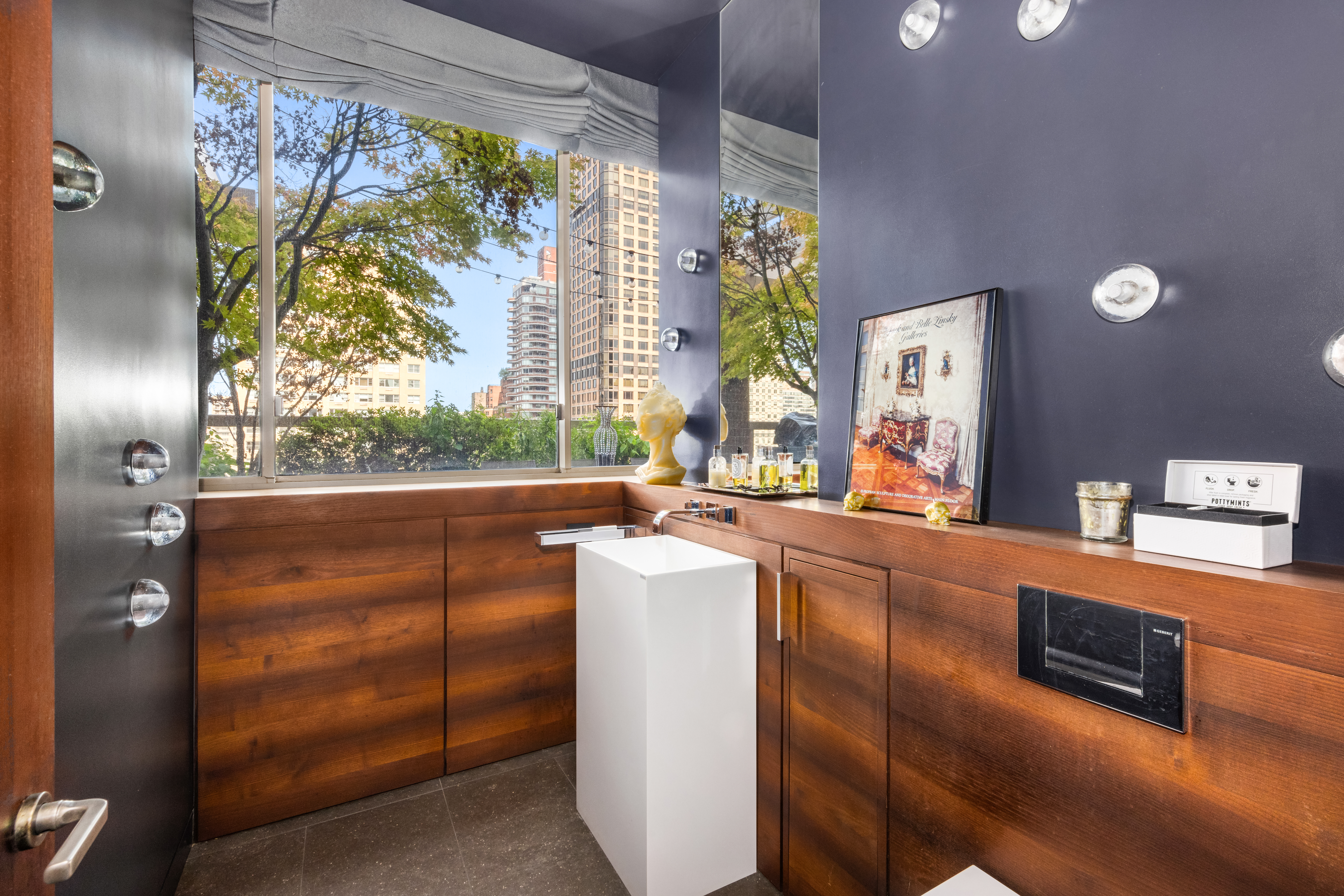 350 East 82nd Street, Unit 14AB Manhattan, NY 10028 - Photo 13 of 21 a living room with furniture a large window and a flat screen tv
