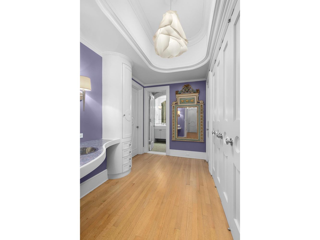 470 Park Avenue, Unit 10C Manhattan, NY 10022 - Photo 8 of 11 a view of a hallway with wooden floor and a living room