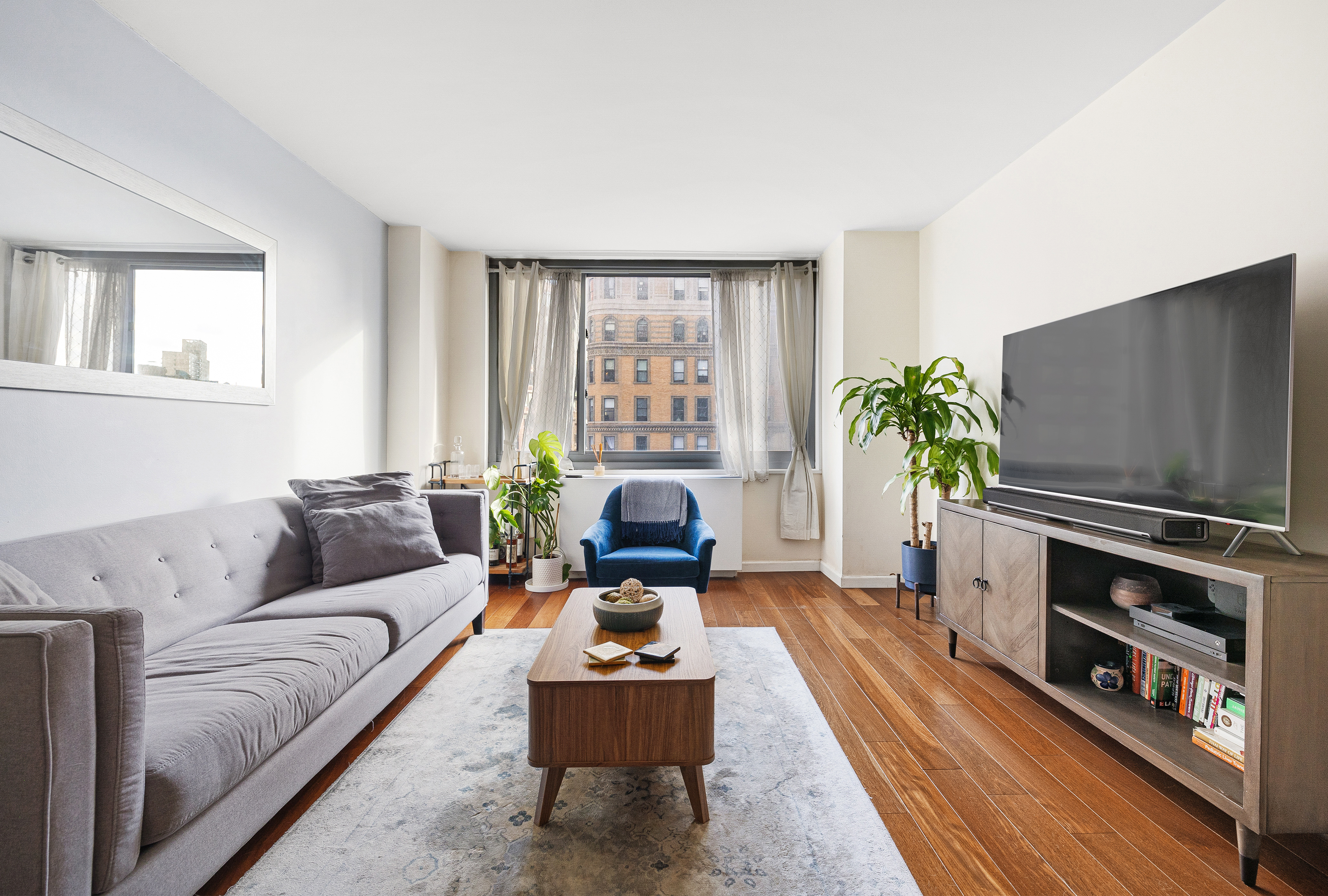 2025 Broadway, Unit 9F Manhattan, NY 10023 - Photo 2 of 11 a living room with furniture fireplace and flat screen tv