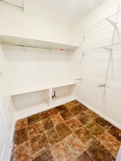 a view of a room with wooden floor and a window