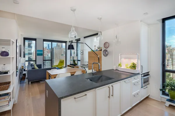 a kitchen with sink stove and cabinets