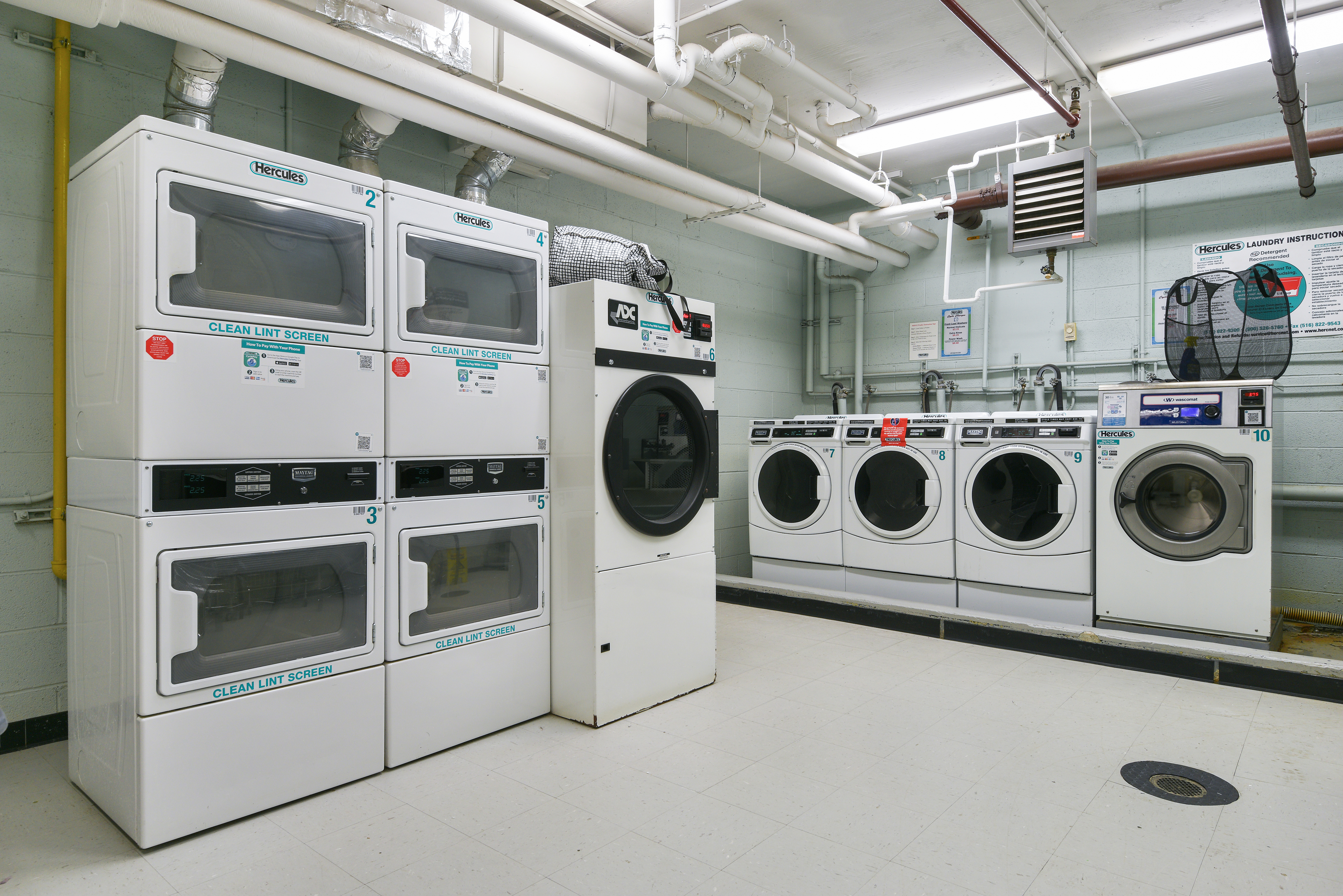 199 Bowery, Unit 11F Manhattan, NY 10002 - Photo 9 of 13 a utility room with dryer and washer
