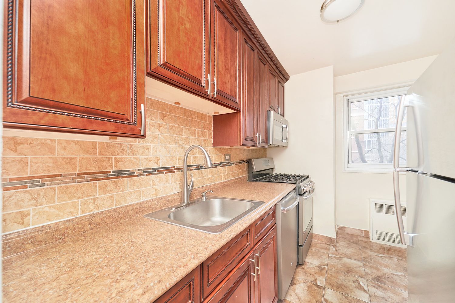 a kitchen with a sink stove and cabinets