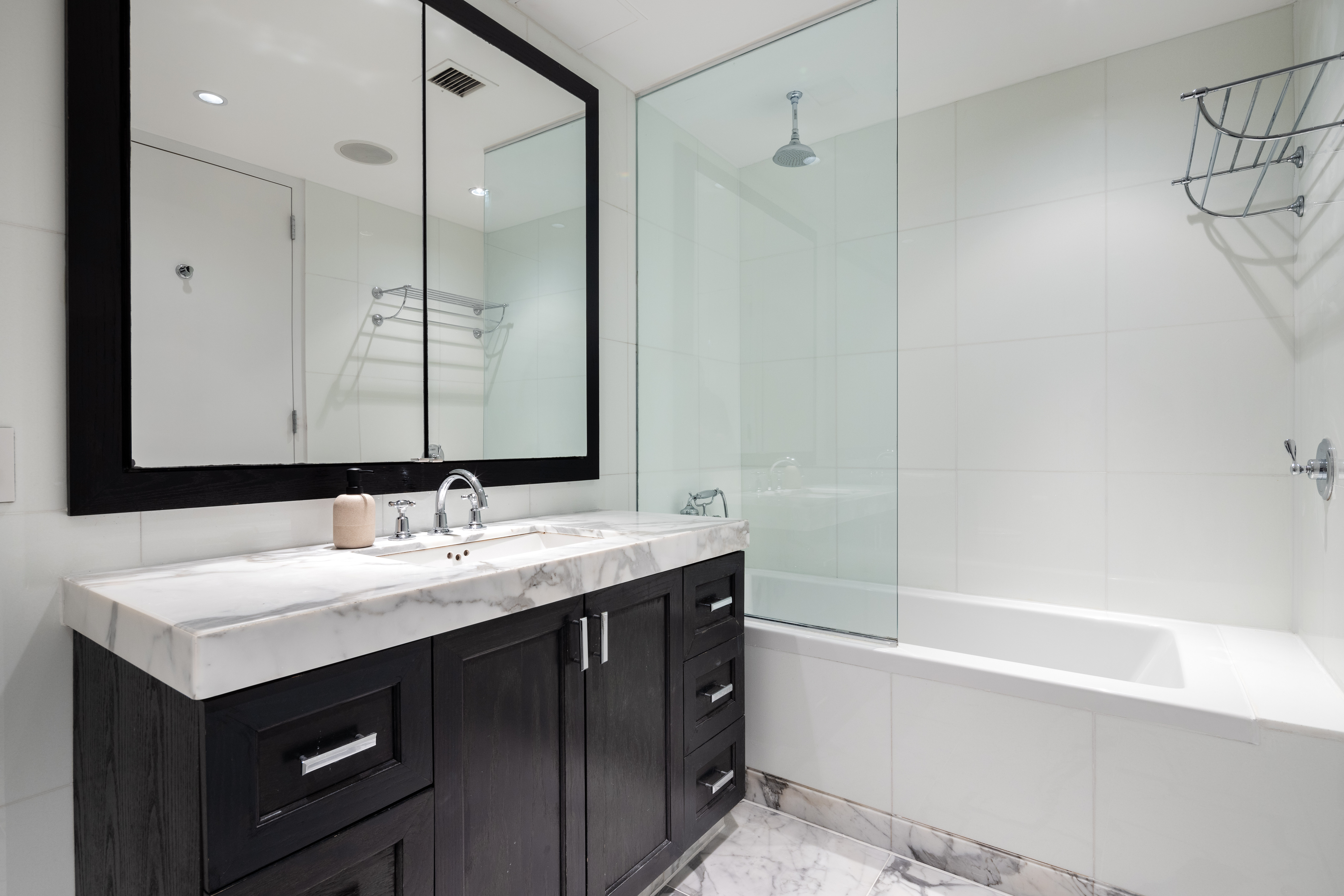 333 Rector Place, Unit 1401 Manhattan, NY 10280 - Photo 5 of 9 a bathroom with a sink and a mirror