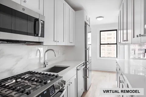 a kitchen with a stove a sink and a window