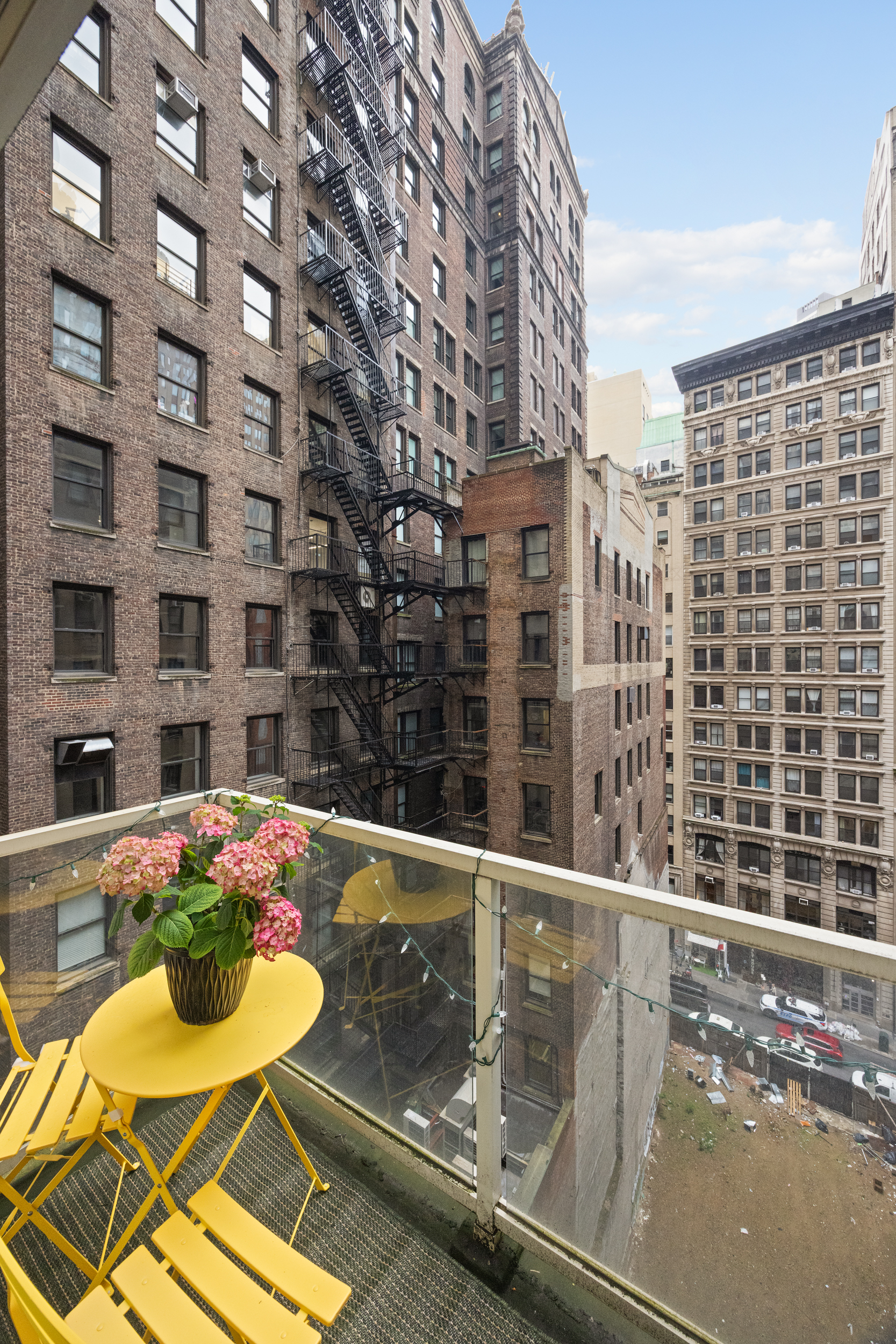 67 Liberty Street, Unit 10 Manhattan, NY 10005 - Photo 9 of 10 a view of a balcony with dining table and chairs