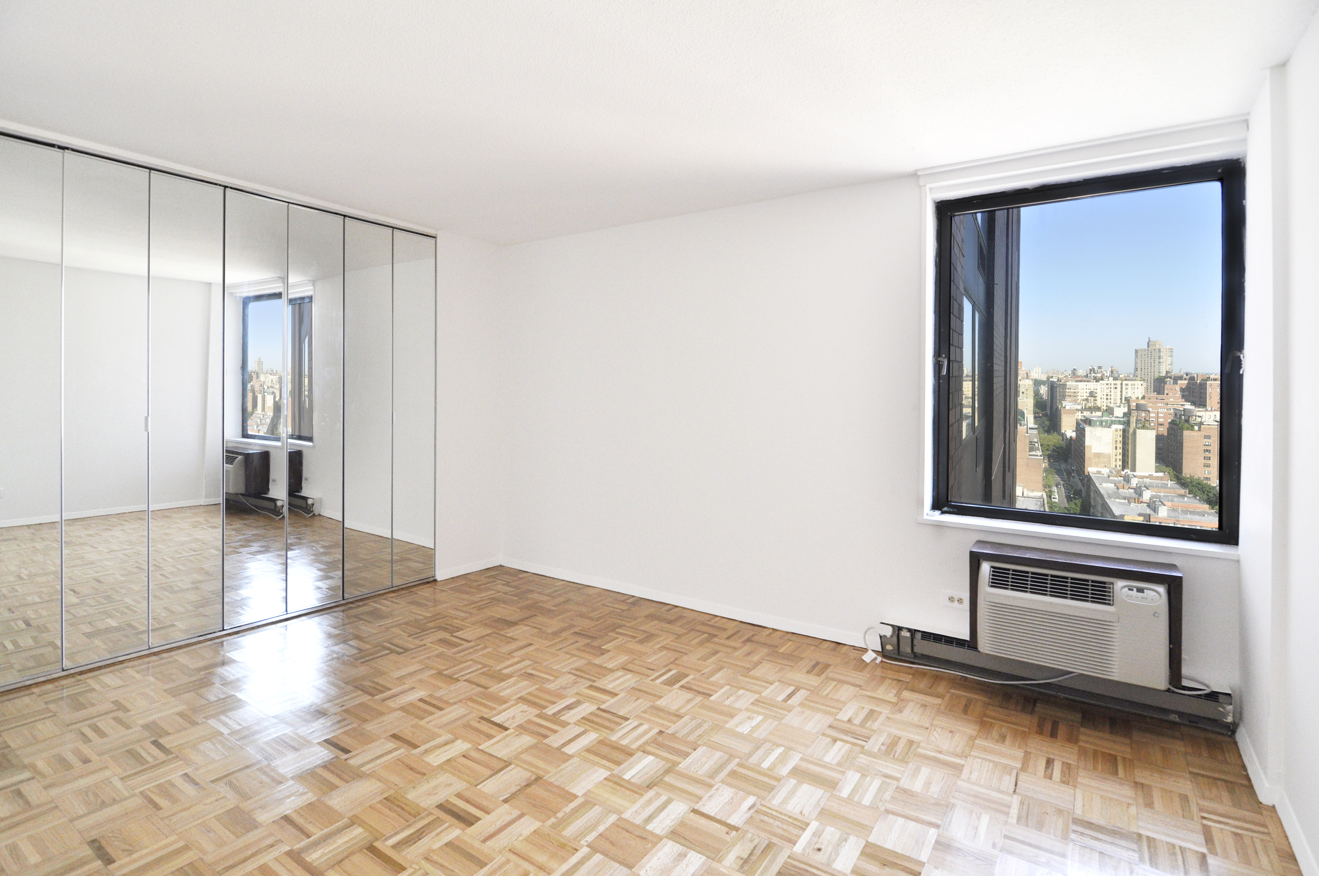 1623 3rd Avenue, Unit 25C Manhattan, NY 10128 - Photo 7 of 12 a view of a hallway with wooden floor and a bathroom