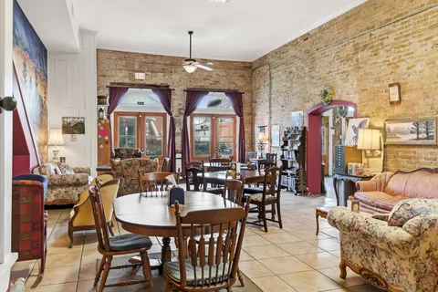 a living room with furniture and a chandelier