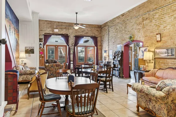 a living room with furniture and a chandelier