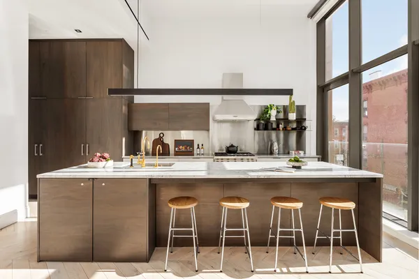 a kitchen with a sink and chairs