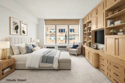 a spacious bedroom with a bed and flat screen tv