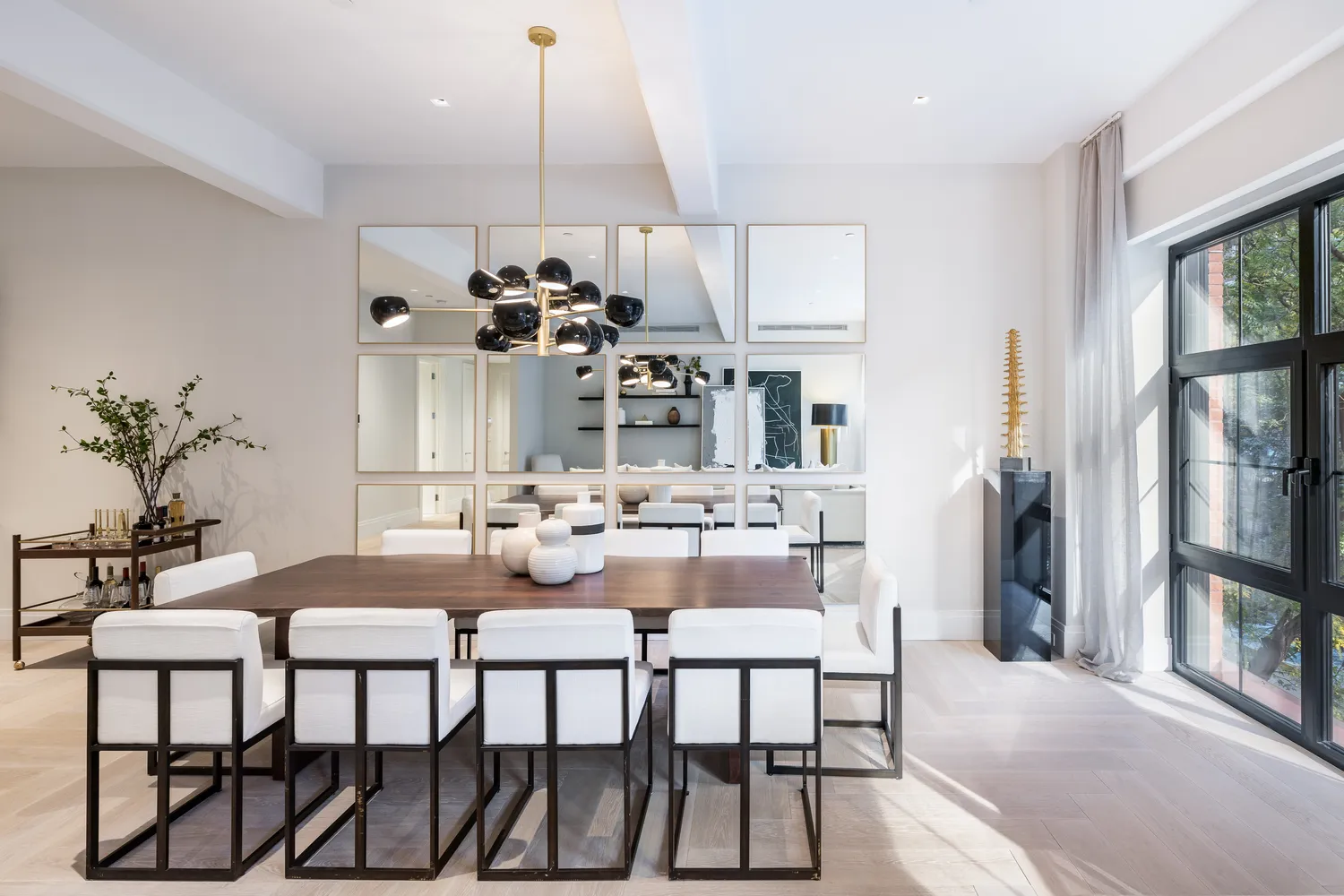 a view of a dining room with furniture and a chandelier