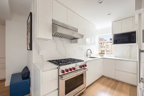 a kitchen with stainless steel appliances a stove a sink and a microwave