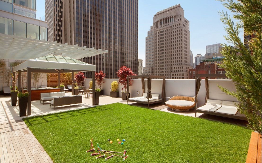 a view of a patio with table and chairs and potted plants