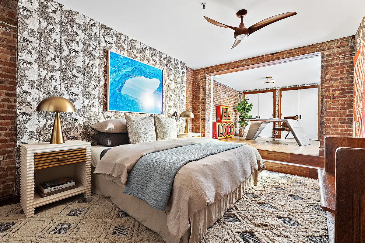 115 Allen Street, Unit 3 Manhattan, NY 10002 - Photo 6 of 13 a view of a bedroom with a bed and wooden floor