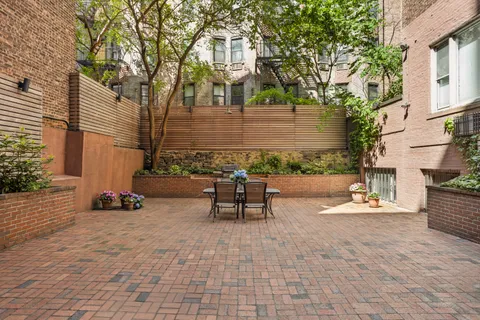 a backyard of a house with table and chairs
