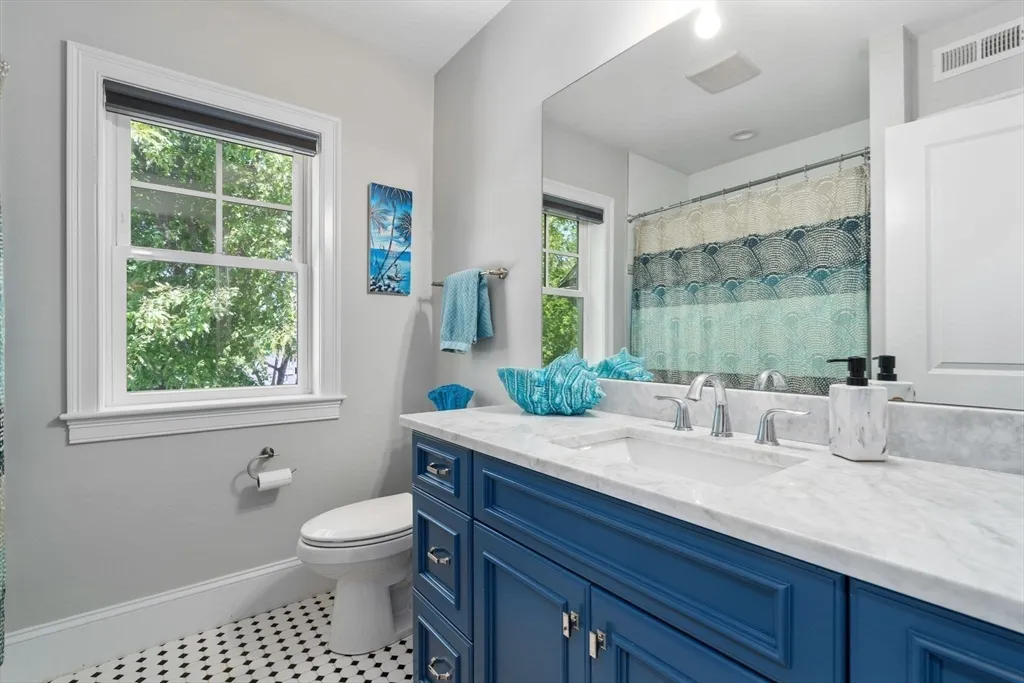 a spacious bedroom with a bed and a large window