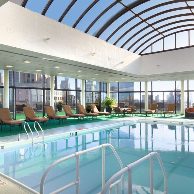 a view of a rooftop and chairs in the patio
