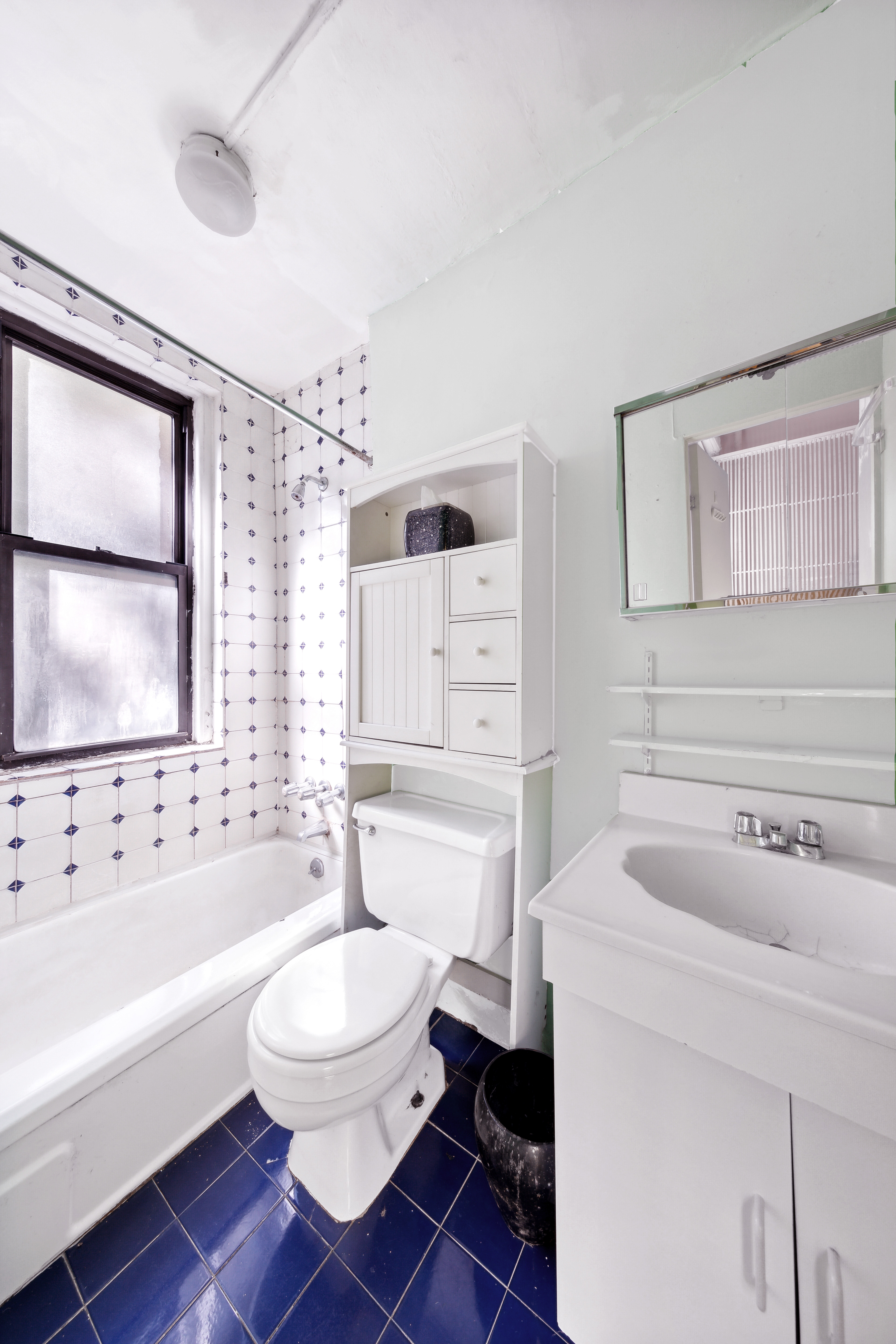 206 East 90th Street, Unit 2E Manhattan, NY 10128 - Photo 8 of 13 a bathroom with a sink toilet a mirror and bathtub