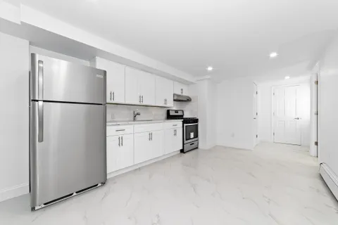 a white refrigerator freezer sitting in a kitchen