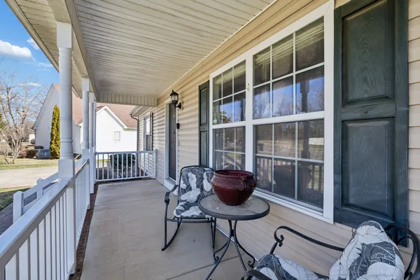 a balcony with table and chairs