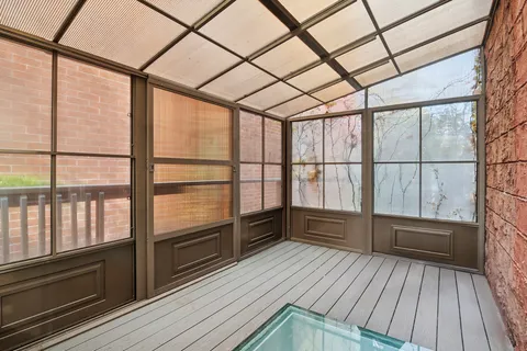 a view of empty room with wooden floor and windows