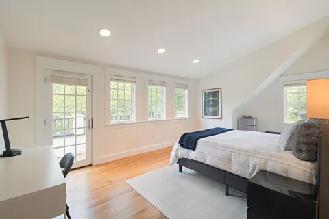a bedroom with a bed and a large window