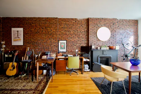a dining room with furniture and wooden floor
