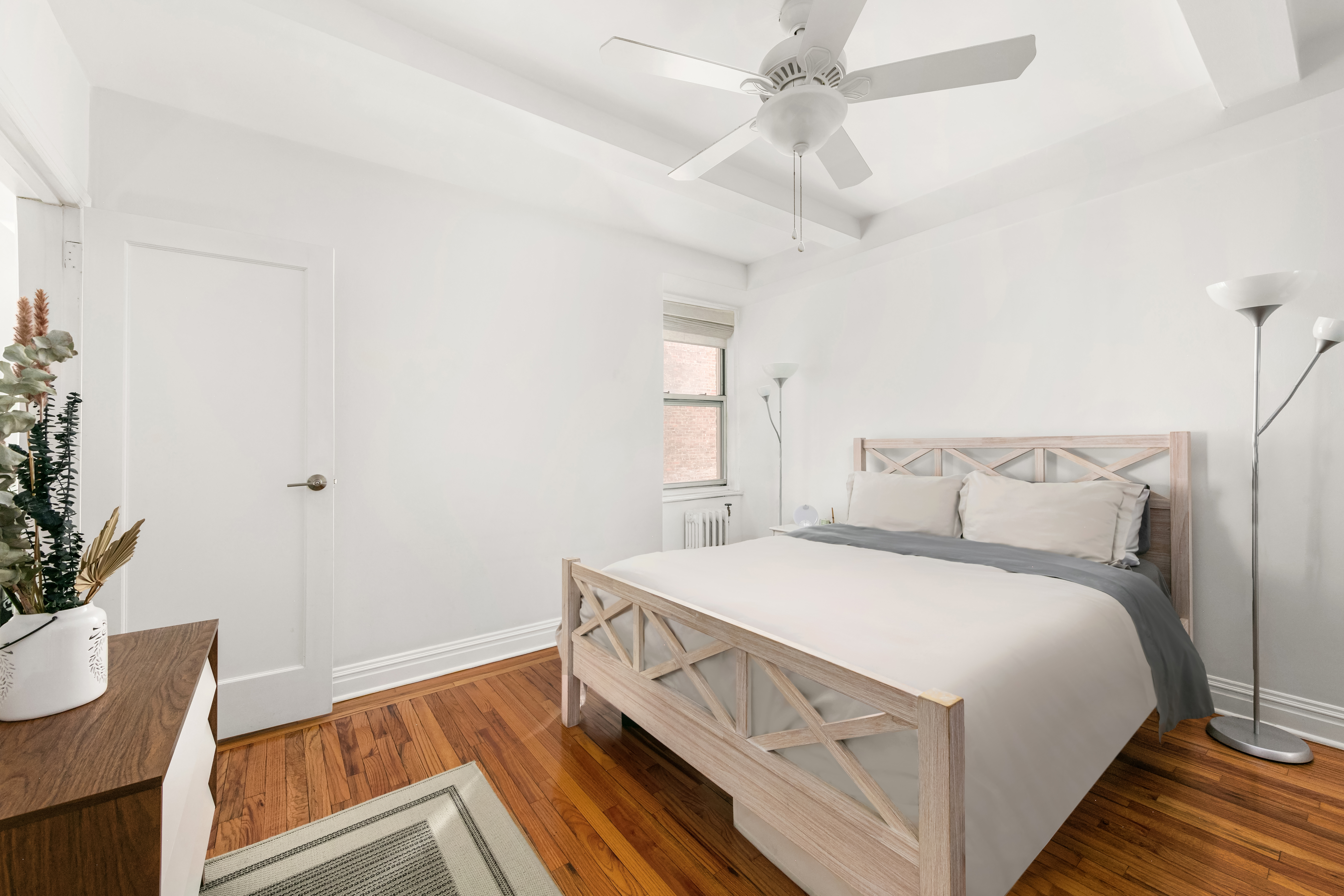 333 East 43rd Street, Unit 311 Manhattan, NY 10017 - Photo 6 of 18 a bedroom with a bed and a potted plant