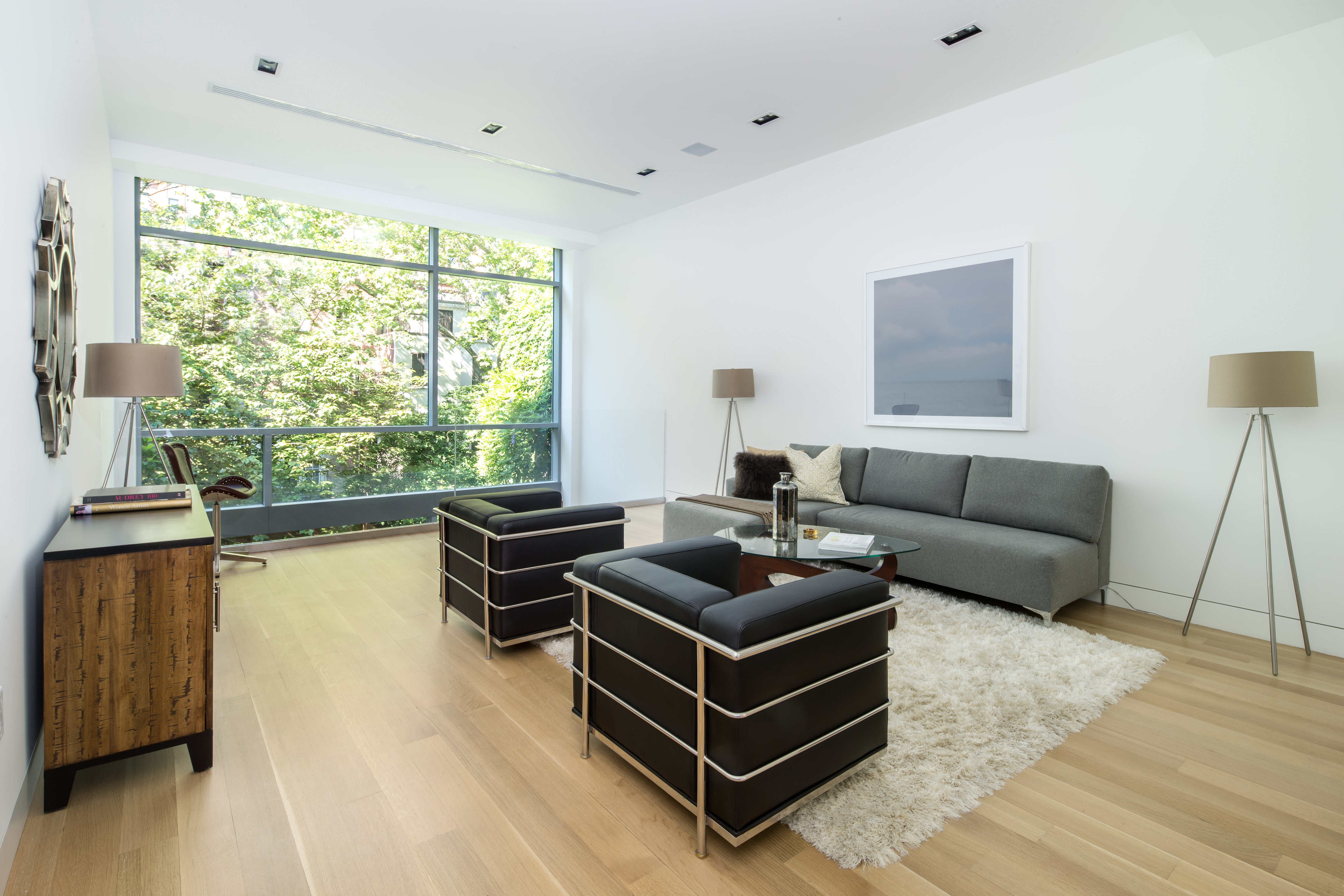 450 West 25th Street Manhattan, NY 10001 - Photo 9 of 16 a living room with furniture and a large window