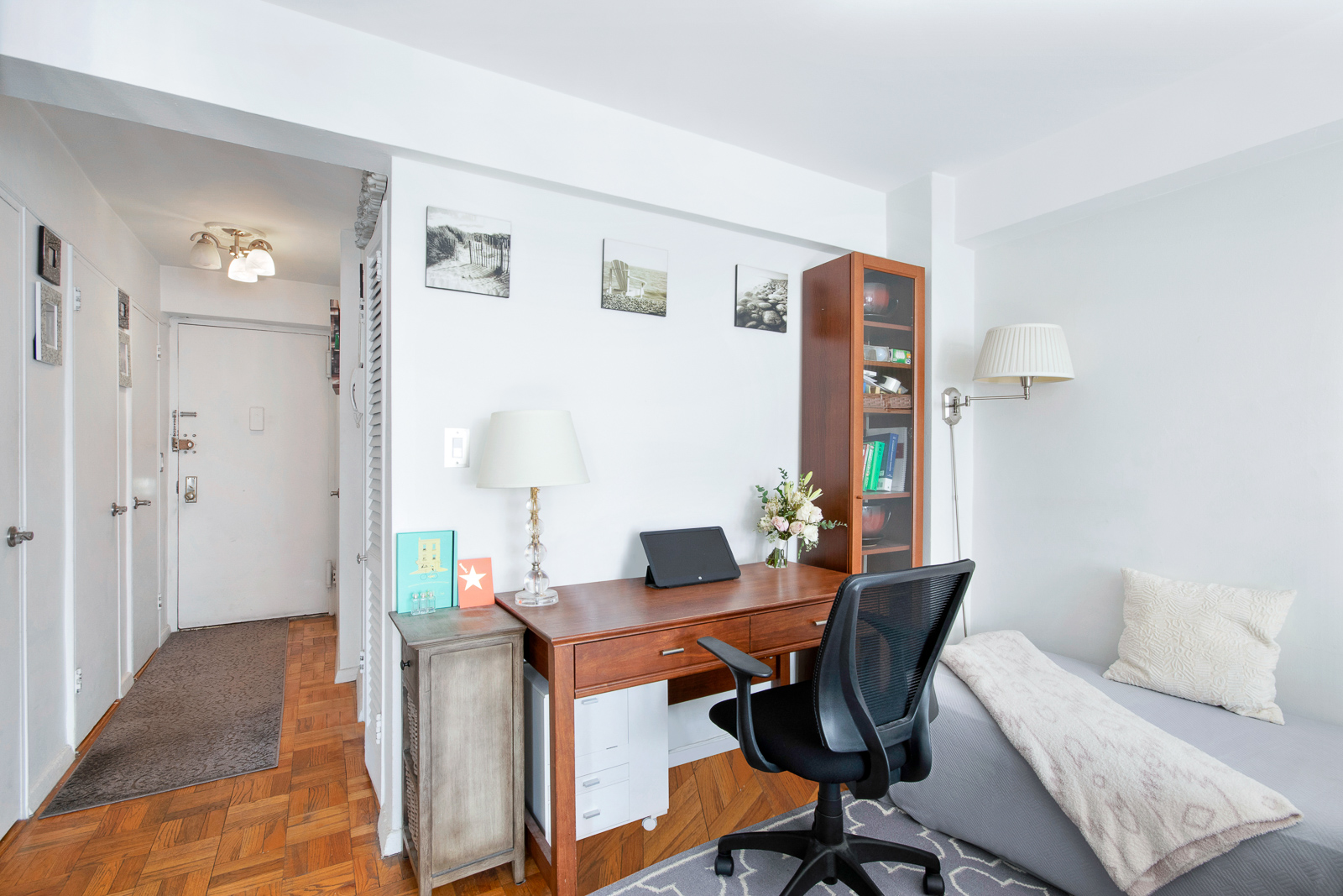 335 East 51st Street, Unit 10C Manhattan, NY 10022 - Photo 3 of 9 a workspace with furniture and wooden floor