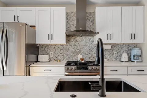 a kitchen with appliances a sink and cabinets