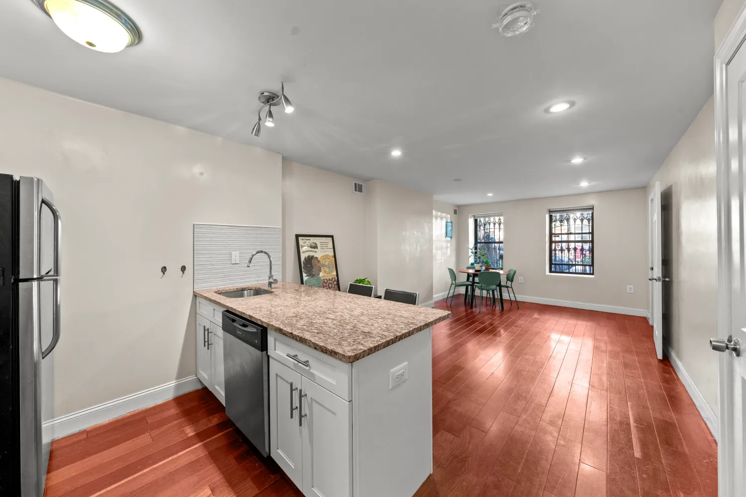 a view of a kitchen counter space and wooden floor