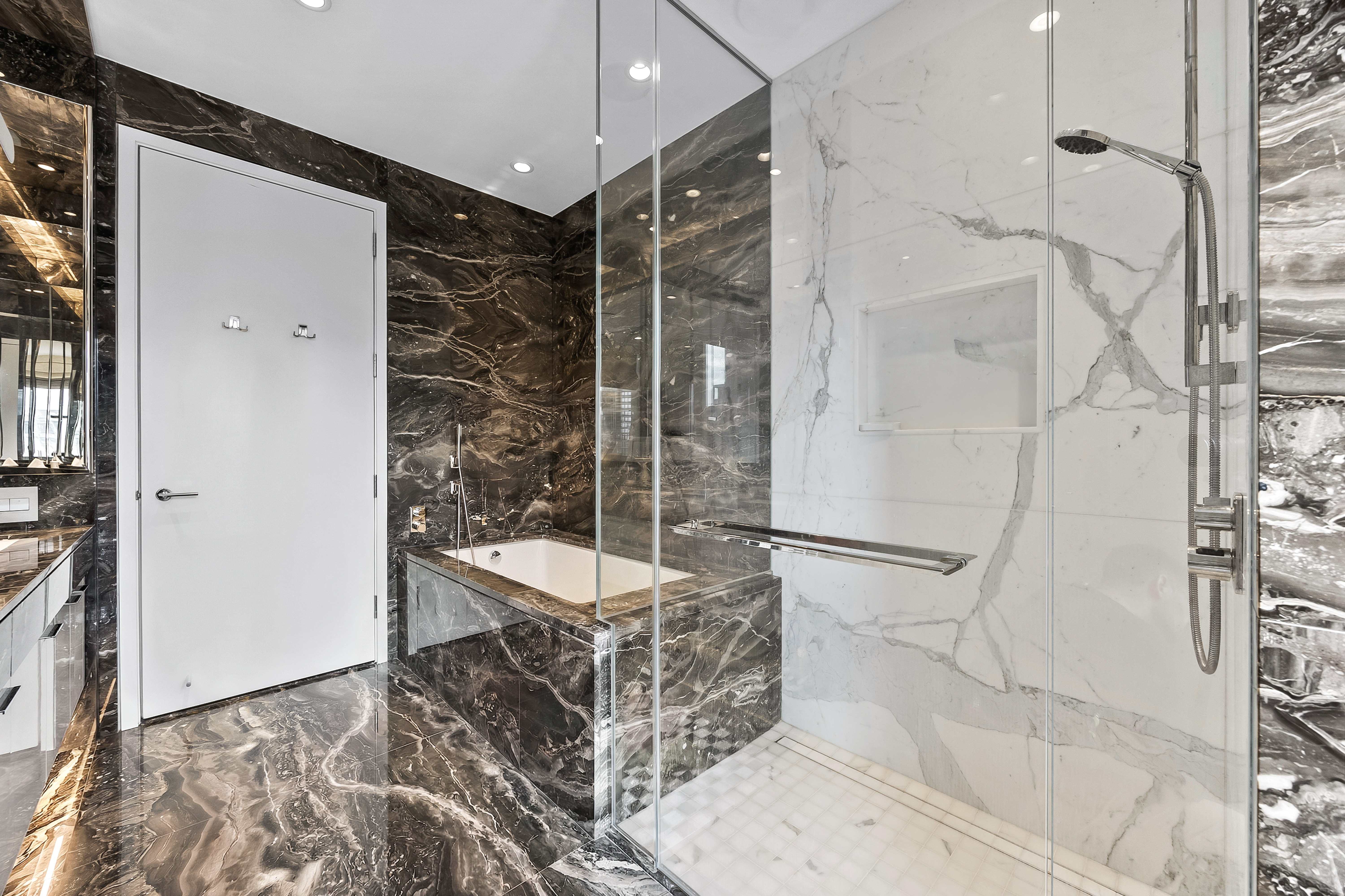 217 West 57th Street, Unit 36D Manhattan, NY 10019 - Photo 10 of 26 a bathroom with a bathtub and a shower